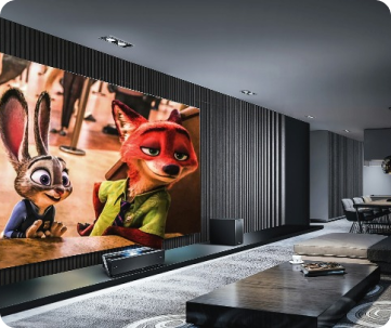 The room features a large screen displaying an animated movie with characters, including a rabbit and a fox, in a scene from a popular film. The space is equipped with comfortable seating, a low coffee table, and ambient lighting, creating an inviting atmosphere for watching movies. The design is minimalist, with a focus on clean lines and a monochromatic color scheme, enhancing the overall cinematic experience.